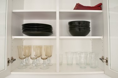 Open kitchen cabinets with dishes and glasses
