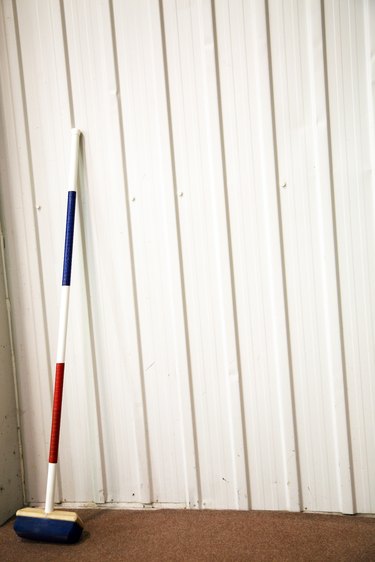 Curling broom on wall