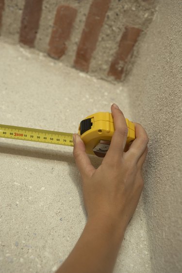 Hand using tape measure