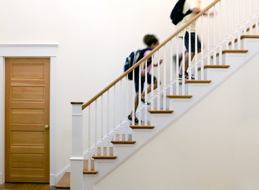 Children running up stairs after school