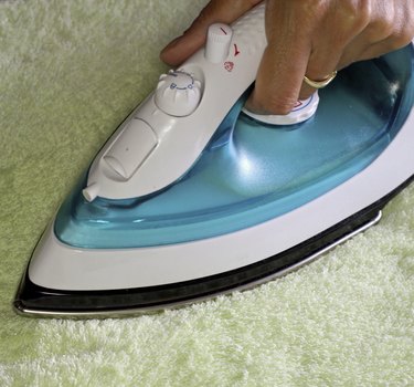 hand with an iron during ironing