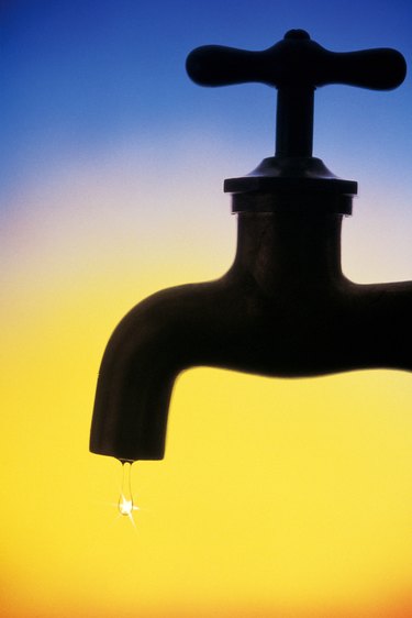 Dripping faucet in silhouette