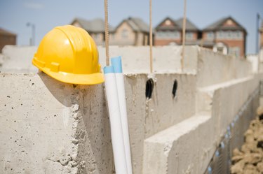 Construction Hat, New Home Foundation and Blueprints