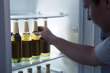 Man taking beer from a fridge