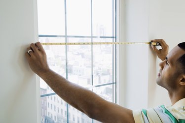 Man measuring window size