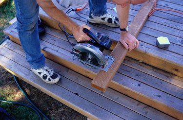 Carpenter Sawing Boards