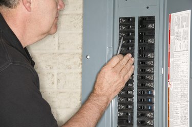 Man checking fuse box