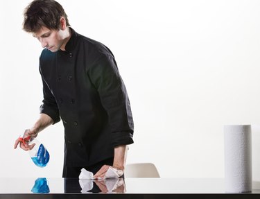 Man wiping surface of table