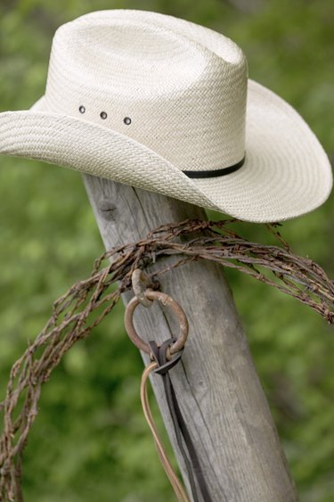 Cowboy hat and lasso on post