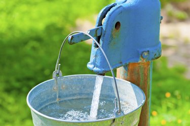 old rusty wheel and a bucket of clean water