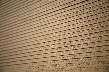 Sheets of particleboard stacked neatly