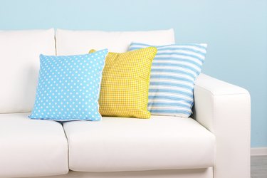 White sofa close-up in room on blue background