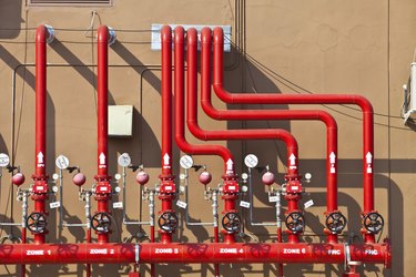 splinker alarm system, red water pipe, brown wall, outdoor