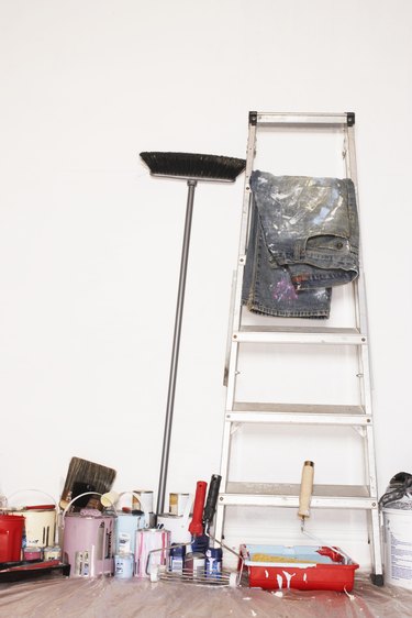 Stepladder and decorating equipment against wall