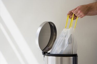 Hands taking out garbage