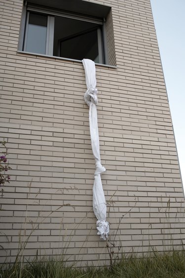 sheets tied to create a rope out of a window