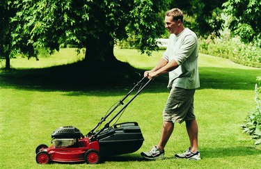 Man Mowing His Lawn During Summer