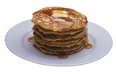 Stack of pancakes with butter and syrup