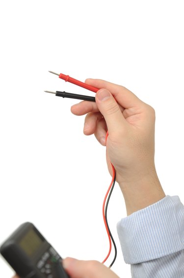 Electrician holding an electric meter