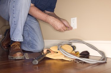 Man working on electrical outlet