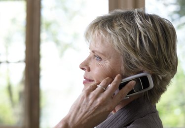 Mature woman using mobile phone, profile, close-up