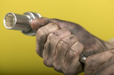 Hand holding socket wrench