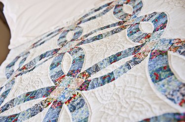 homemade "wedding rings" quilt on a bed