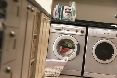Laundry in washing machine in kitchen