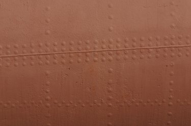 Painted surface of metal with rivets