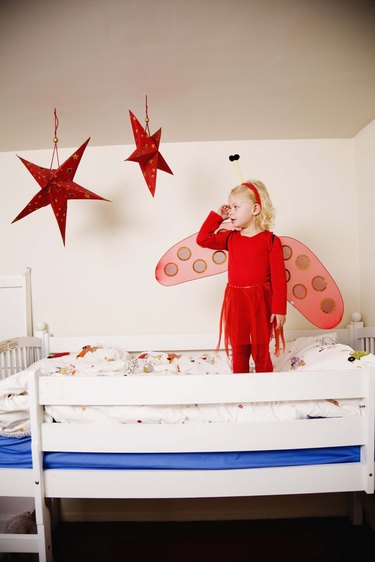 Girl in fairy costume on bunk bed