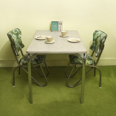 Retro 50' || chr(39) || 's formica and chrome dinette set with green vinyl chairs.