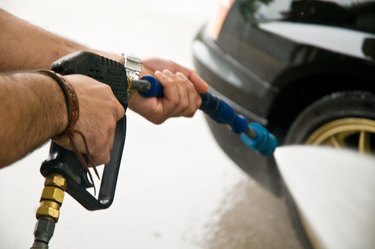 Hands with a car wash sprayer