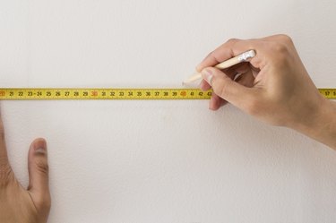 Closeup of a measuring tape and  pencil