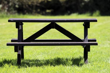 Image of wooden picnic table in field of mown grass