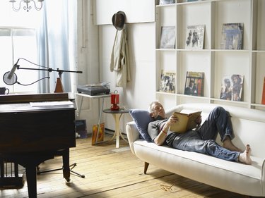 Mature man lying down, reading