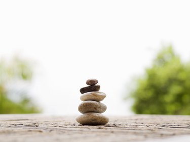 Stack of pebbles on table outdoors, close-up (surface level)
