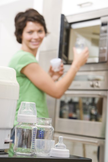 Woman microwaving bottle