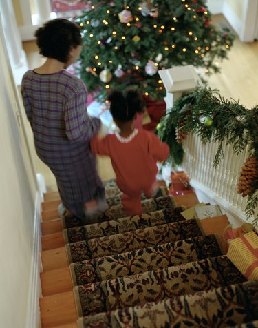 Mother and Daughter Walking Down Stairs on Christmas Morning