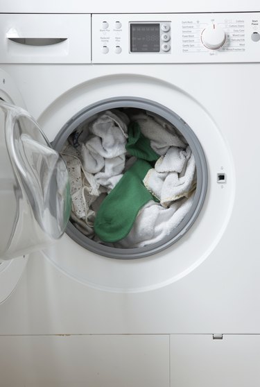 white washing in machine one green sock