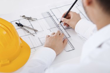 Architect working on blueprints