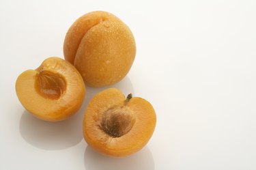 Two apricots, one split in half