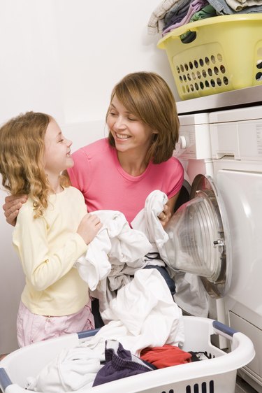 Woman doing laundry with child