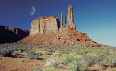 Moon over an arid landscape, Monument Valley Navajo Tribal Park, Arizona, USA