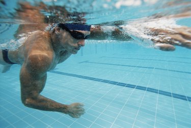 Underwater Shot of a Young Man Swimming in a Pool