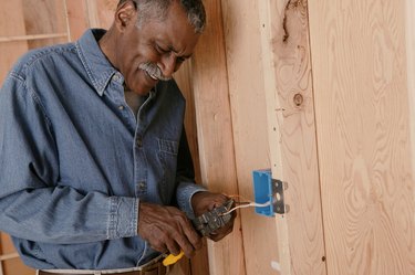 Man installing electrical outlet