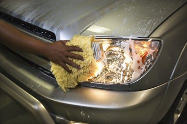 Hand cleaning headlight of car