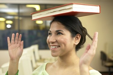 Girl balancing a book on her head