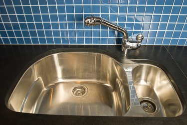 High angle view of kitchen sink by tiled wall
