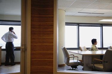 View through window to businesspeople working