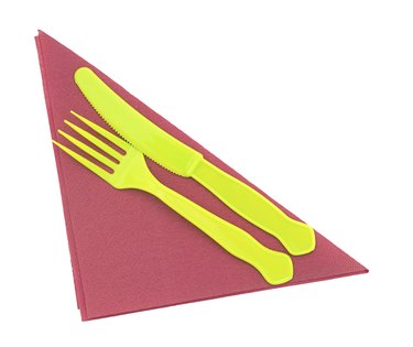 Bright green plastic knife and fork on red serviette, napkin.